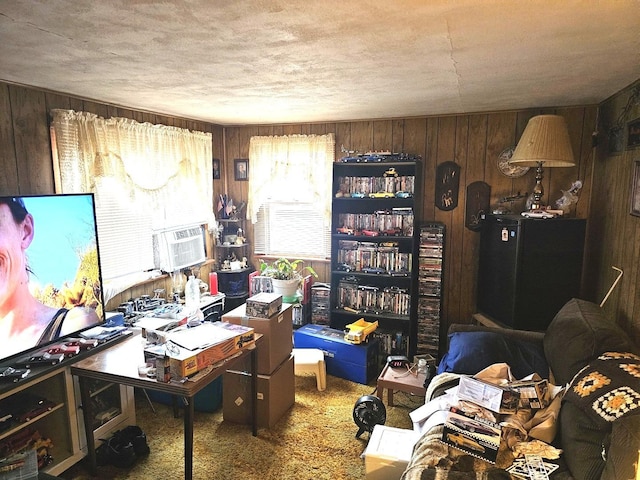 carpeted home office featuring wood walls, a textured ceiling, and cooling unit