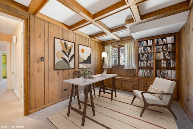 home office with beam ceiling, wood walls, coffered ceiling, and light carpet