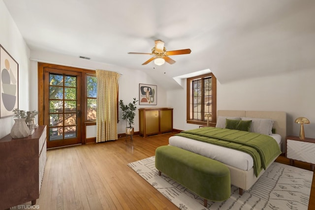 bedroom featuring ceiling fan, visible vents, baseboards, and hardwood / wood-style floors