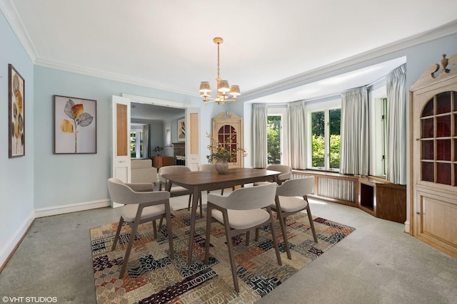 dining space with a notable chandelier, baseboards, carpet, and ornamental molding