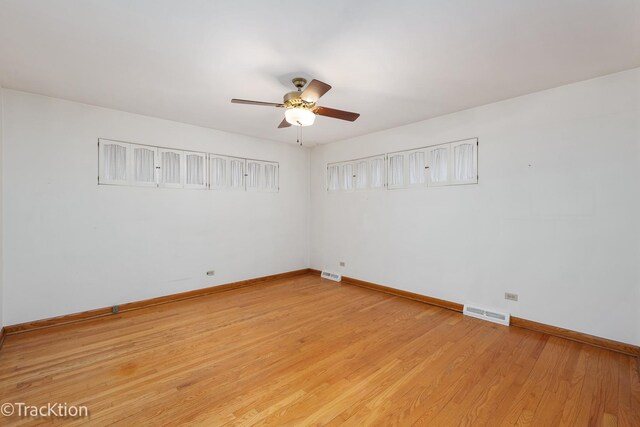 unfurnished room featuring light wood-style flooring, visible vents, ceiling fan, and baseboards