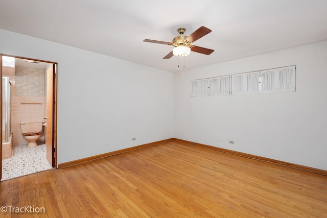 unfurnished room featuring light wood-type flooring, ceiling fan, and baseboards