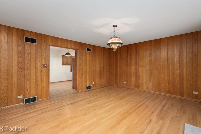 unfurnished room featuring visible vents and light wood finished floors