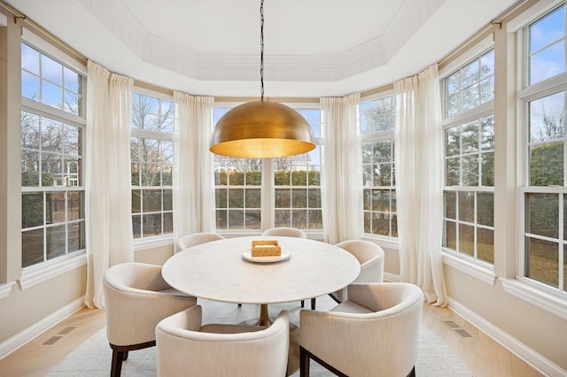 sunroom with visible vents and a tray ceiling