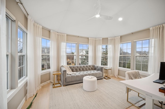 sunroom featuring lofted ceiling, a healthy amount of sunlight, and ceiling fan