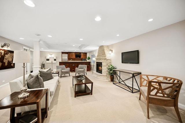 living room with recessed lighting, a fireplace, and light carpet