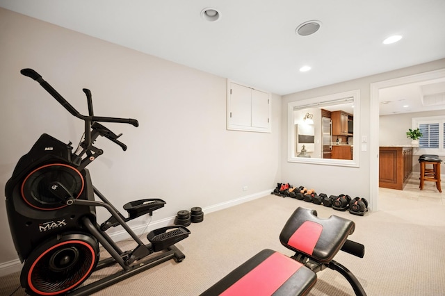 exercise room featuring recessed lighting, baseboards, and light carpet