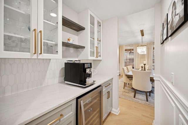 kitchen featuring light wood-style flooring, decorative backsplash, open shelves, wine cooler, and glass insert cabinets