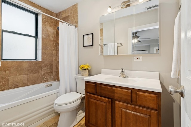 bathroom featuring visible vents, vanity, shower / bath combination with curtain, toilet, and a ceiling fan
