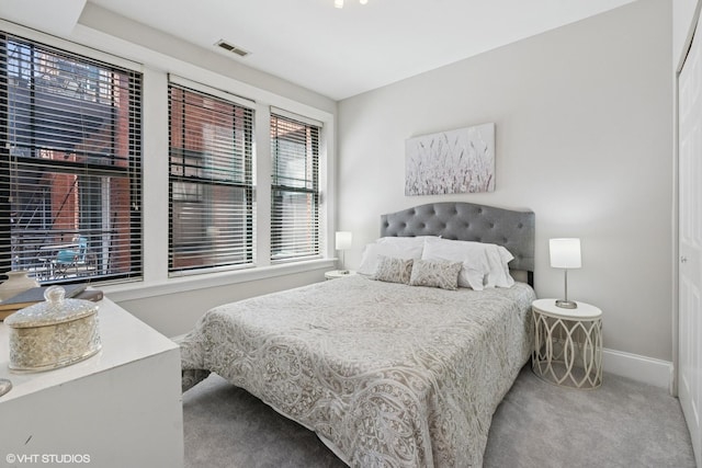 bedroom featuring baseboards, visible vents, and carpet