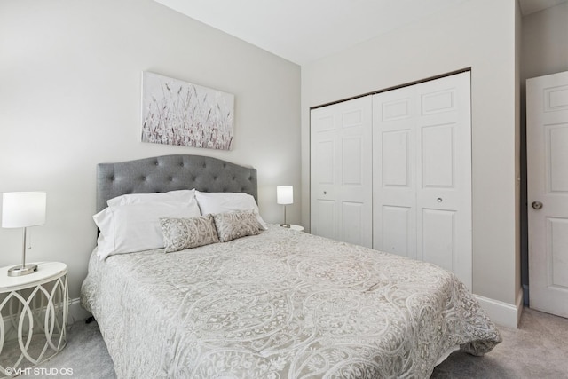 carpeted bedroom featuring baseboards and a closet