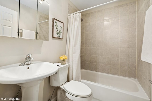 bathroom with shower / tub combo with curtain and toilet