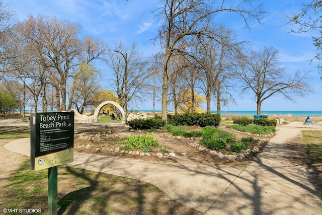 surrounding community featuring a water view and a view of the beach