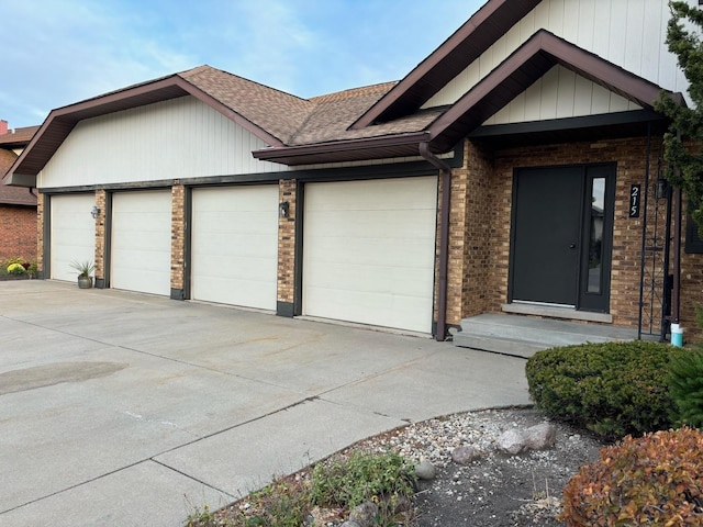 single story home featuring brick siding, driveway, an attached garage, and roof with shingles