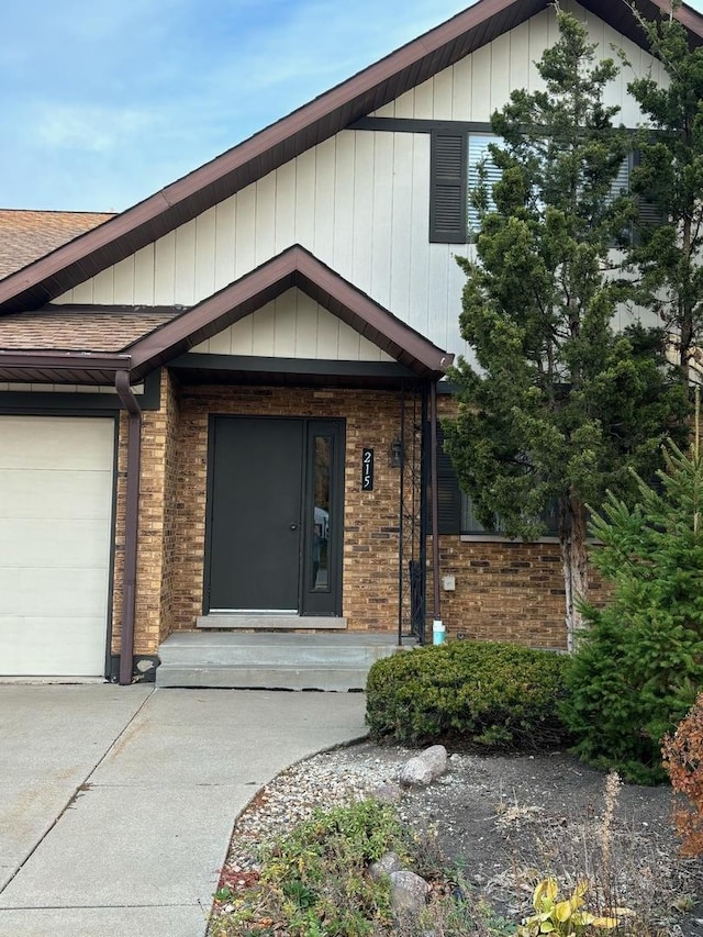 view of front facade with a garage, brick siding, driveway, and roof with shingles