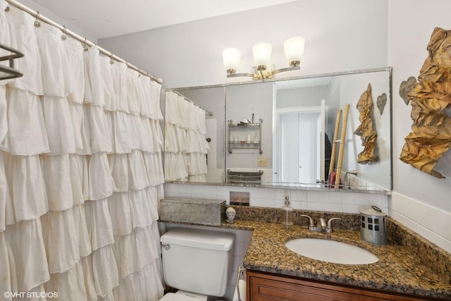 bathroom featuring curtained shower, toilet, backsplash, and vanity