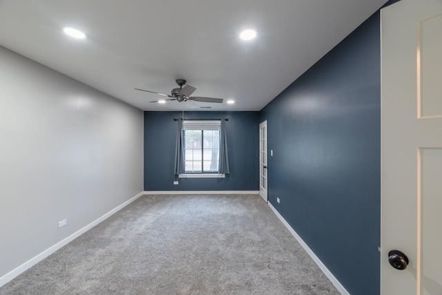 carpeted spare room featuring recessed lighting, a ceiling fan, and baseboards