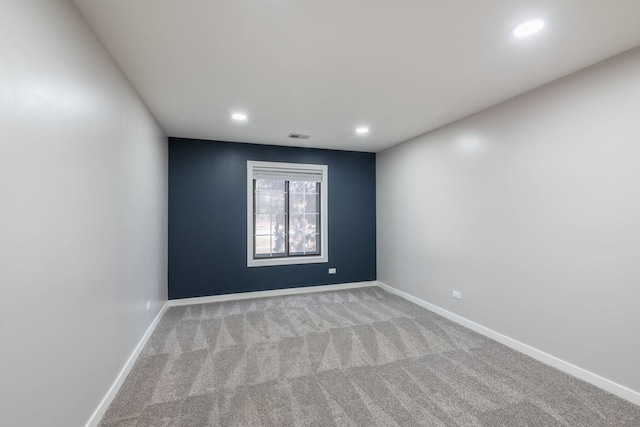 spare room with visible vents, baseboards, carpet flooring, and recessed lighting