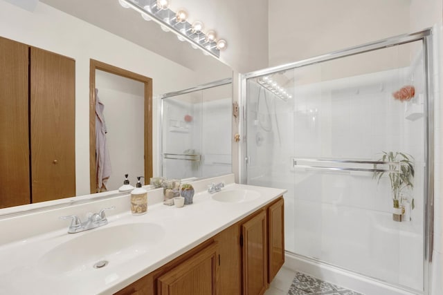 full bath with double vanity, a stall shower, and a sink