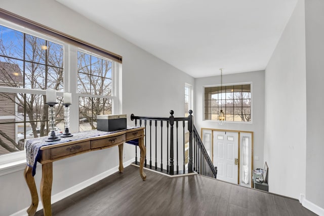 entrance foyer featuring a high ceiling, baseboards, and wood finished floors