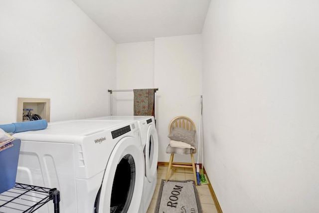 laundry room featuring light tile patterned floors, laundry area, independent washer and dryer, and baseboards