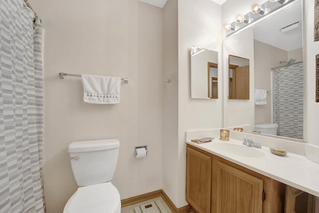 bathroom with a shower with shower curtain, vanity, toilet, and baseboards