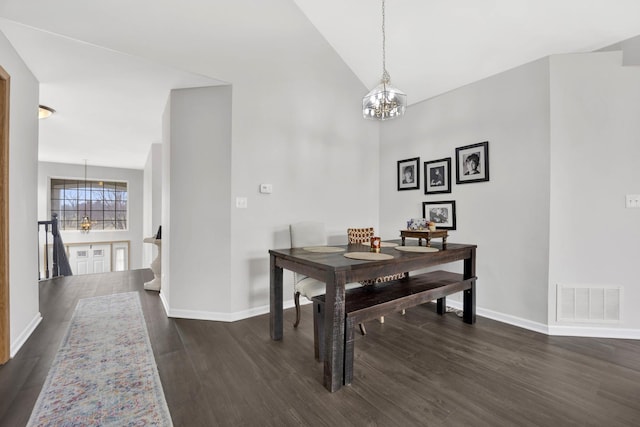 dining space with dark wood finished floors, visible vents, a notable chandelier, and baseboards