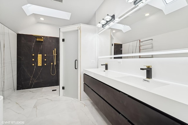 full bathroom with double vanity, vaulted ceiling with skylight, a marble finish shower, marble finish floor, and a sink