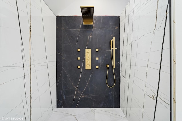 bathroom featuring a marble finish shower