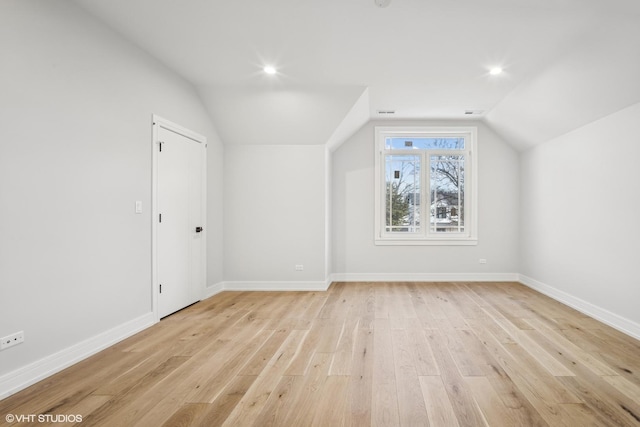 bonus room with light wood-type flooring, lofted ceiling, baseboards, and recessed lighting