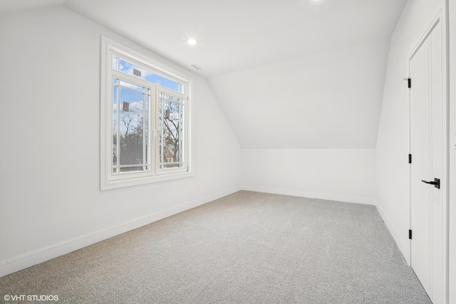 additional living space featuring carpet, vaulted ceiling, baseboards, and recessed lighting