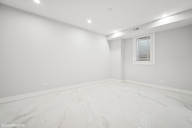 finished basement featuring recessed lighting, marble finish floor, visible vents, and baseboards