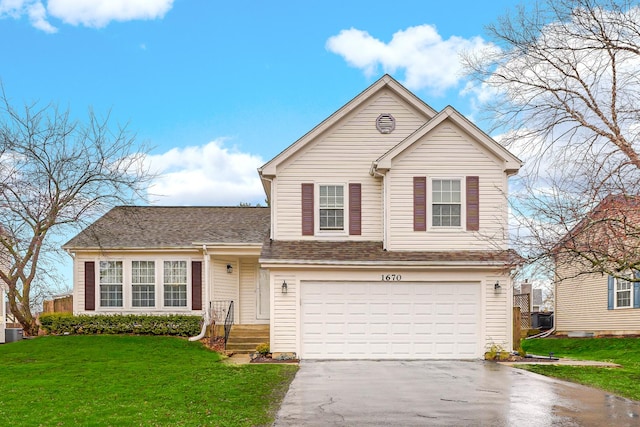 traditional home with a garage, driveway, and a front lawn