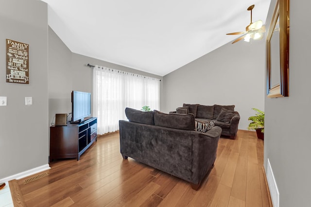 living area with visible vents, vaulted ceiling, light wood-style flooring, and ceiling fan