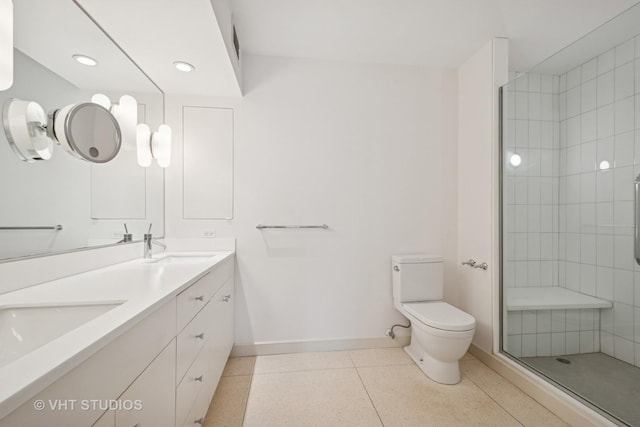 bathroom with baseboards, a sink, tile patterned flooring, a shower stall, and toilet