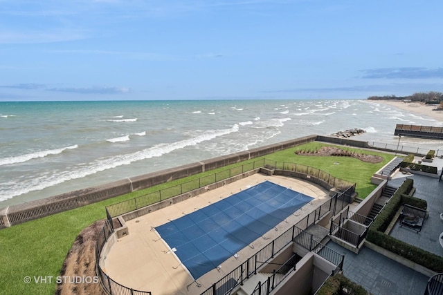 view of pool featuring a fenced in pool, a water view, and fence