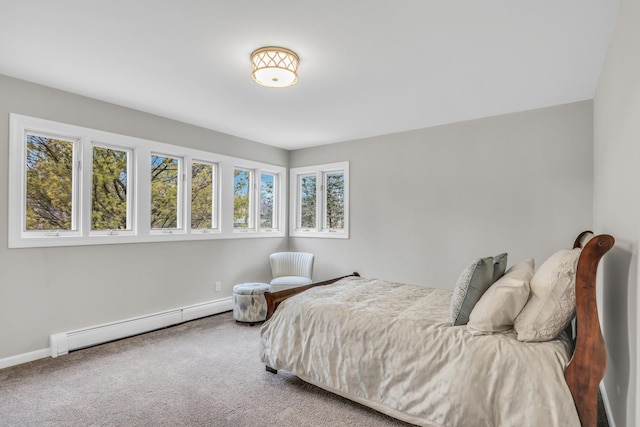 carpeted bedroom featuring baseboards and a baseboard heating unit