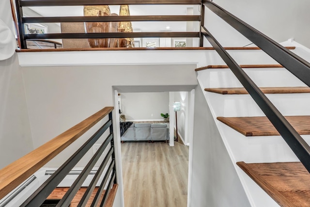 stairway featuring wood finished floors