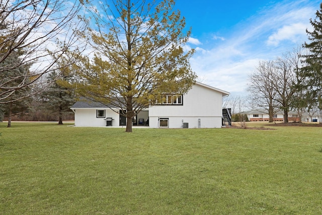 rear view of house featuring a yard