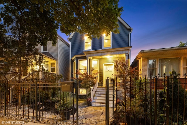 traditional-style home with a fenced front yard