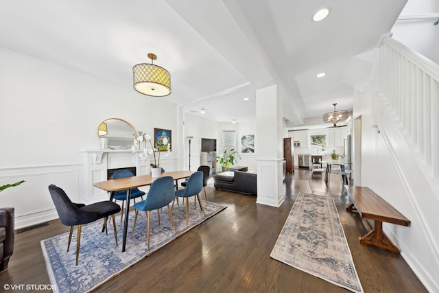 dining area featuring visible vents, dark wood-type flooring, ornate columns, a decorative wall, and recessed lighting