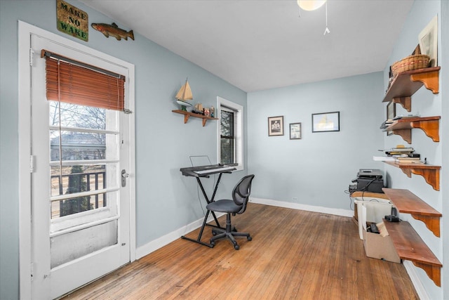 home office with hardwood / wood-style floors and baseboards