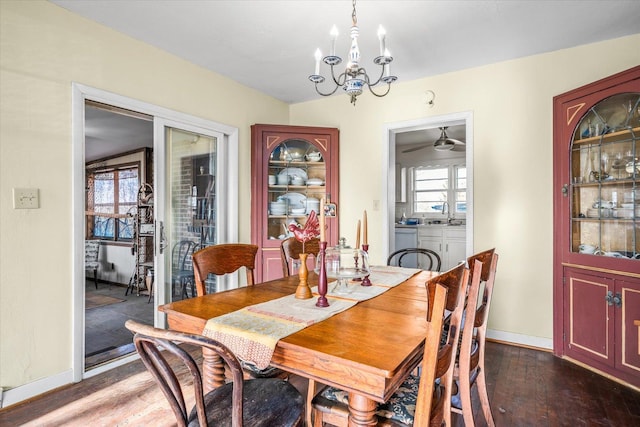 dining room featuring baseboards, an inviting chandelier, and wood finished floors