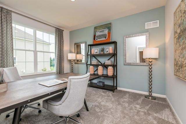 carpeted office with baseboards and visible vents