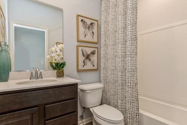 bathroom with toilet, shower / bath combo, and vanity