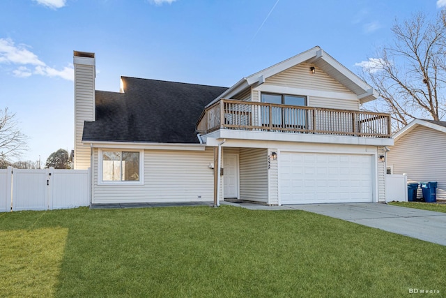 traditional-style house featuring a garage, fence, a front lawn, and concrete driveway