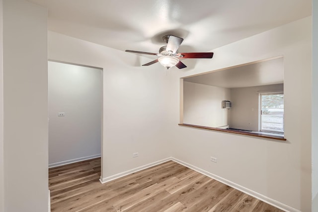 unfurnished room with ceiling fan, baseboards, and wood finished floors