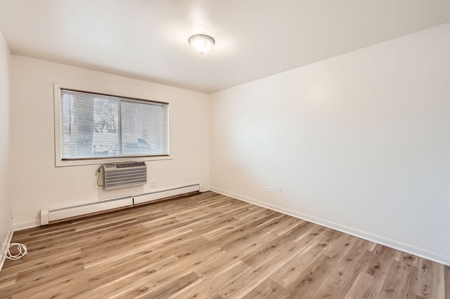 spare room with light wood-type flooring, baseboards, a baseboard heating unit, and a wall mounted AC