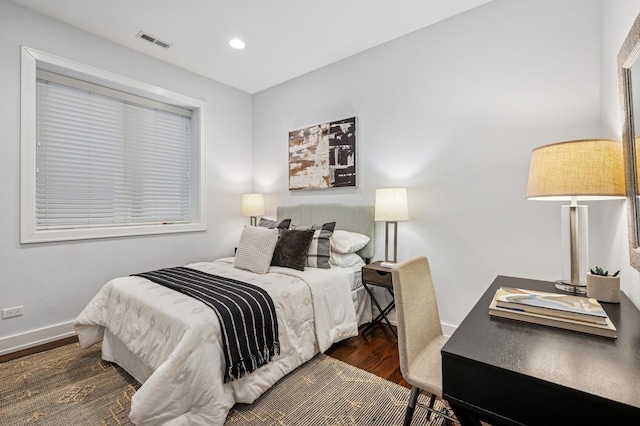 bedroom with recessed lighting, wood finished floors, visible vents, and baseboards