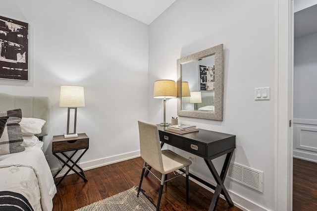 office with wood finished floors, visible vents, and baseboards